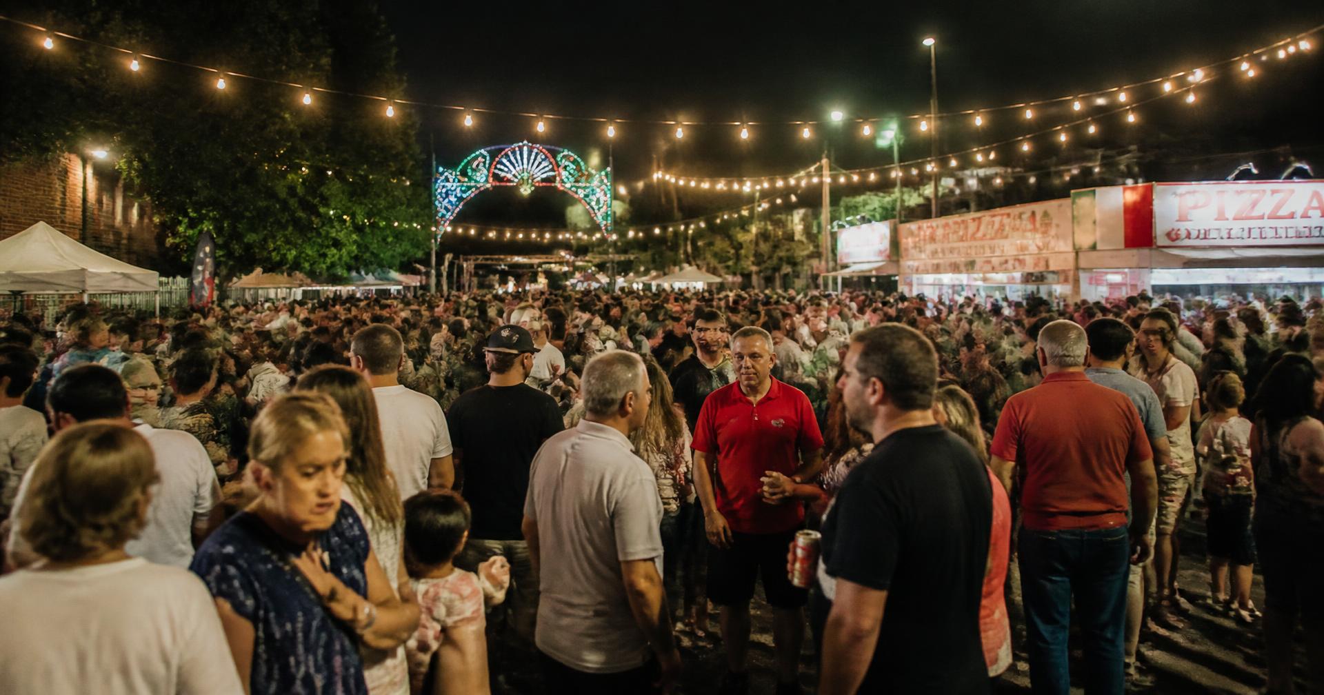 A crowd of members and neighbors at an evening heritage festival